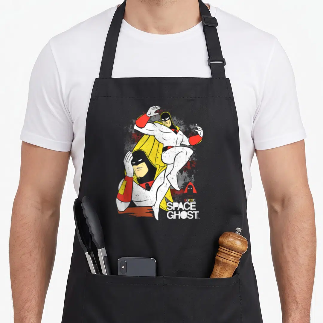 Space superhero apron - Two overlapping Space Ghost cartoon figures with printed text in white, yellow, red, and black — shown on a black cotton canvas apron against a white background