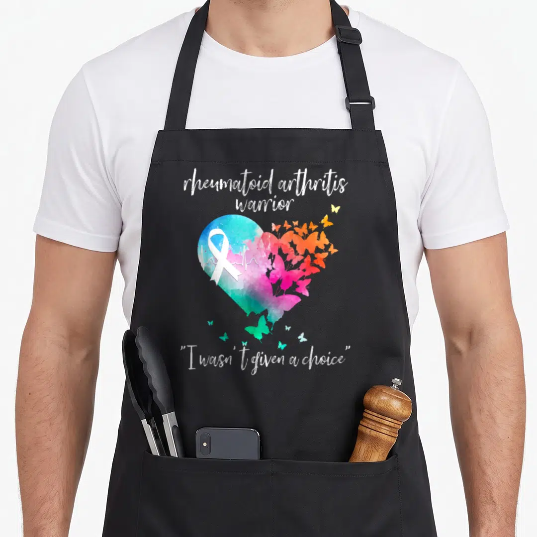 Arthritis warrior ribbon apron - Watercolor heart with white ribbon, heartbeat line, and butterflies in blue pink orange — shown on a black cotton canvas apron against a white background