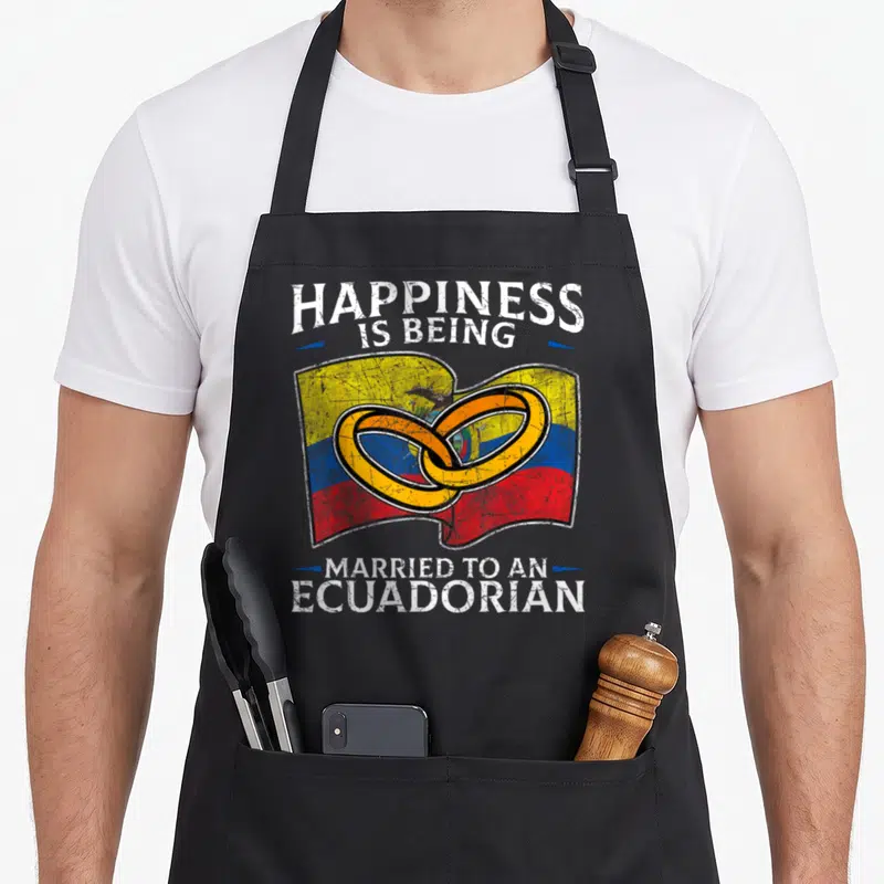 Ecuadorian wedding apron - Flag of Ecuador with two interlocking gold rings and distressed white text reading happiness — shown on a black cotton canvas apron against a white background