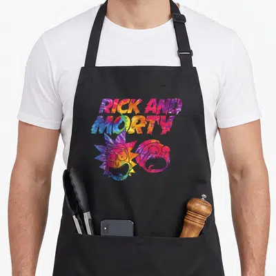Mademark tie dye apron - RICK AND MORTY dripping text above pink and blue cartoon heads — shown on a black cotton canvas apron against a white background