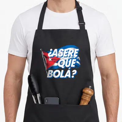 Cubanita cuba cuban pride apron - Waving Cuban flag with ASERE QUE BOLA text in blue and white cartoon style — shown on a black cotton canvas apron against a white background