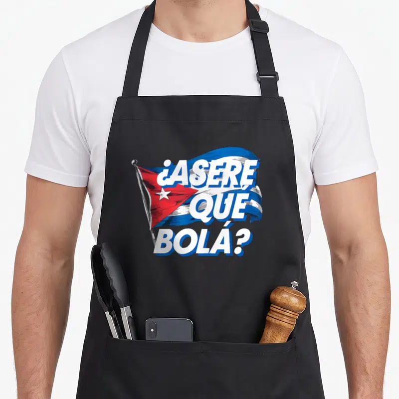 Cubanita cuba cuban pride apron - Waving Cuban flag with ASERE QUE BOLA text in blue and white cartoon style — shown on a black cotton canvas apron against a white background