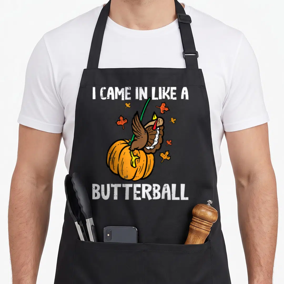 Came thanksgiving apron - Cartoon turkey jumping into orange pumpkin with text I CAME IN LIKE A BUTTERBALL — shown on a black cotton canvas apron against a white background