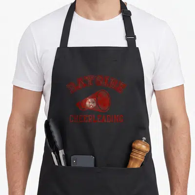 Bayside bell apron - Red megaphone with tiger head and BAYSIDE CHEERLEADING text in distressed font — shown on a black cotton canvas apron against a white background