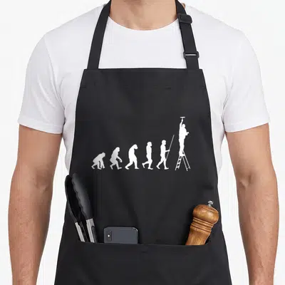 Evolution painter apron - Six white silhouettes showing evolution ending with a man on a ladder — shown on a black cotton canvas apron against a white background