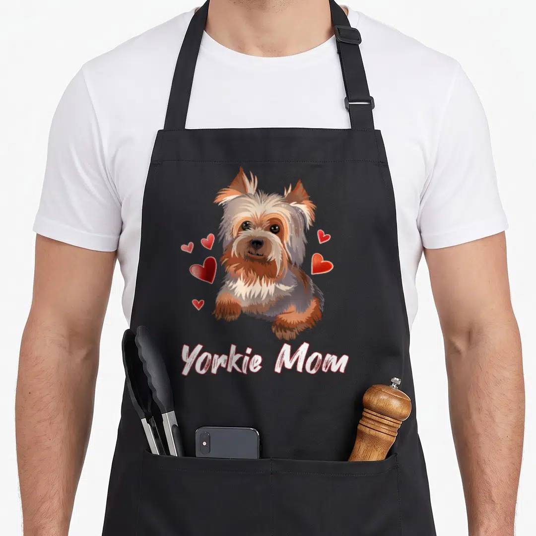 Illustration yorkie apron - Realistic Yorkshire Terrier head surrounded by red hearts with Yorkie Mom text below — shown on a black cotton canvas apron against a white background