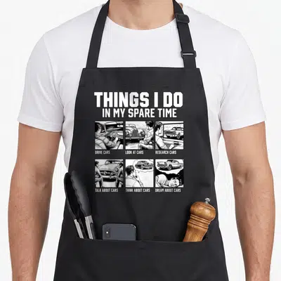 Car spare mechanic apron - Retro comic grid listing drive, look at, research, talk about, think about, and dream about — shown on a black cotton canvas apron against a white background