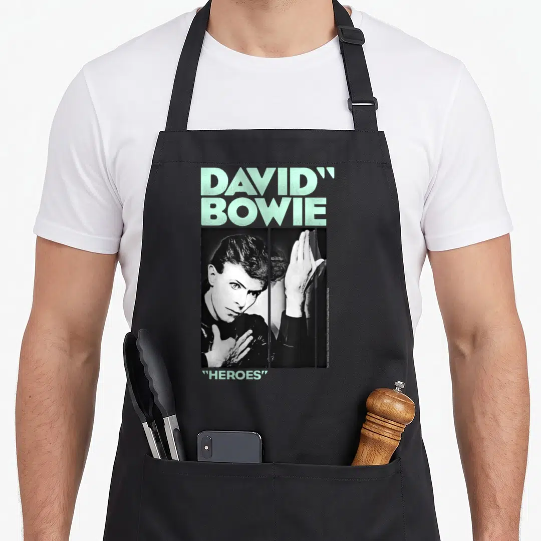 Festive david aprons - Distressed David Bowie Heroes portrait with mint text and split hand imagery — shown on a black cotton canvas apron against a white background