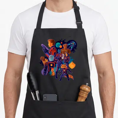 Cosmic galaxies apron - Guardians of the Galaxy team in blue, red, purple, and orange cartoon style with planets — shown on a black cotton canvas apron against a white background