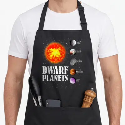 Solar planet nerd apron - Realistic sun and five labeled dwarf planets Ceres Pluto Haumea Makemake Eris — shown on a black cotton canvas apron against a white background