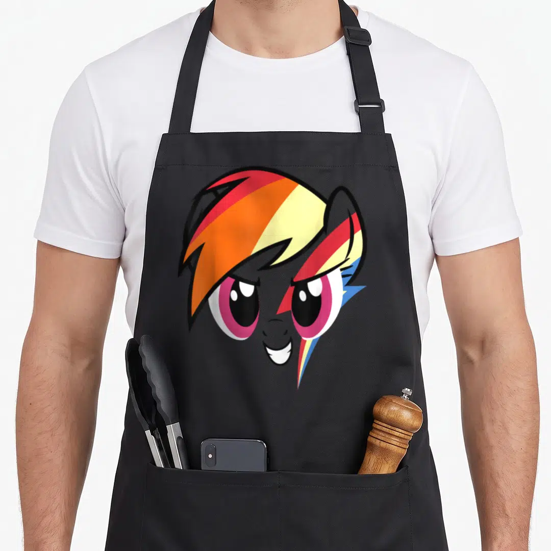 Rainbow magic apron - Stylized grey pony head with wide eyes, smiling mouth, and striped mane ending in a lightning bolt — shown on a black cotton canvas apron against a white background
