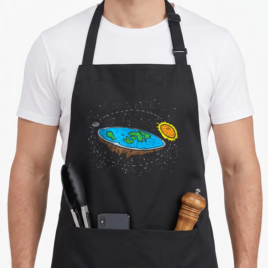 Flat galaxies jokes apron - Cartoon flat earth disc with sun moon and stars in blue green orange yellow white — shown on a black cotton canvas apron against a white background
