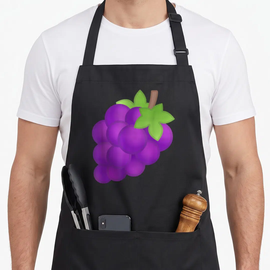 Costume grapes apron - Cartoon purple grape cluster with green leaves and brown stem — shown on a black cotton canvas apron against a white background