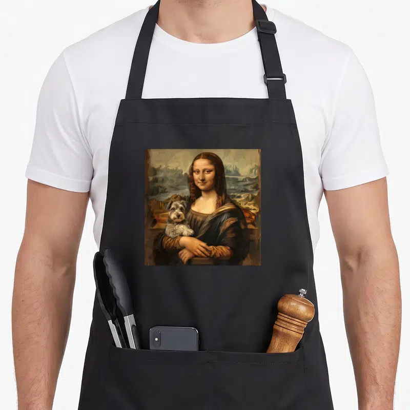 Cute miniature schnauzer apron - Realistic painting of Mona Lisa holding a miniature schnauzer against a landscape — shown on a black cotton canvas apron against a white background