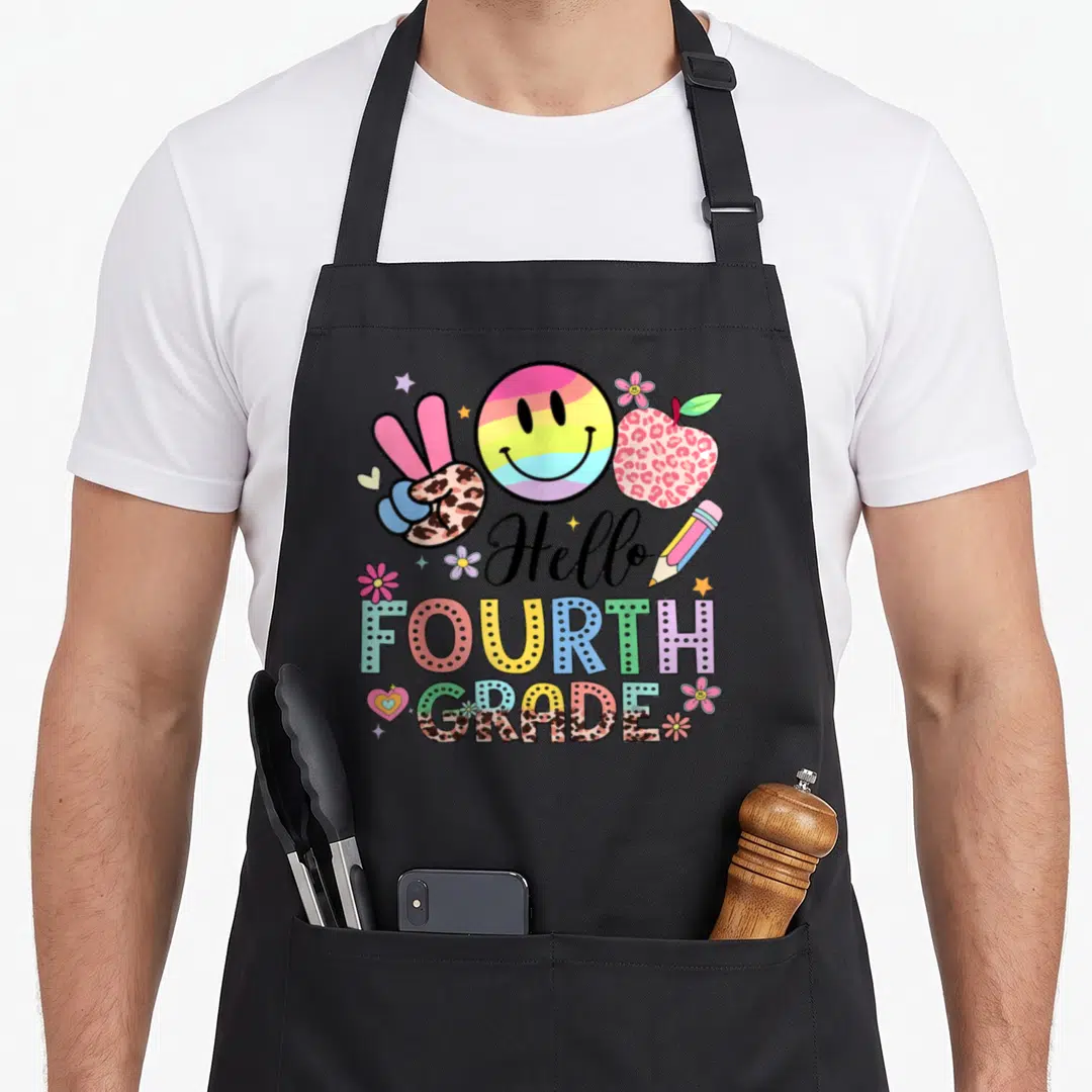 Hello 4th grade teacher apron - Rainbow smiley face, leopard apple, peace sign, and Hello FOURTH GRADE text — shown on a black cotton canvas apron against a white background
