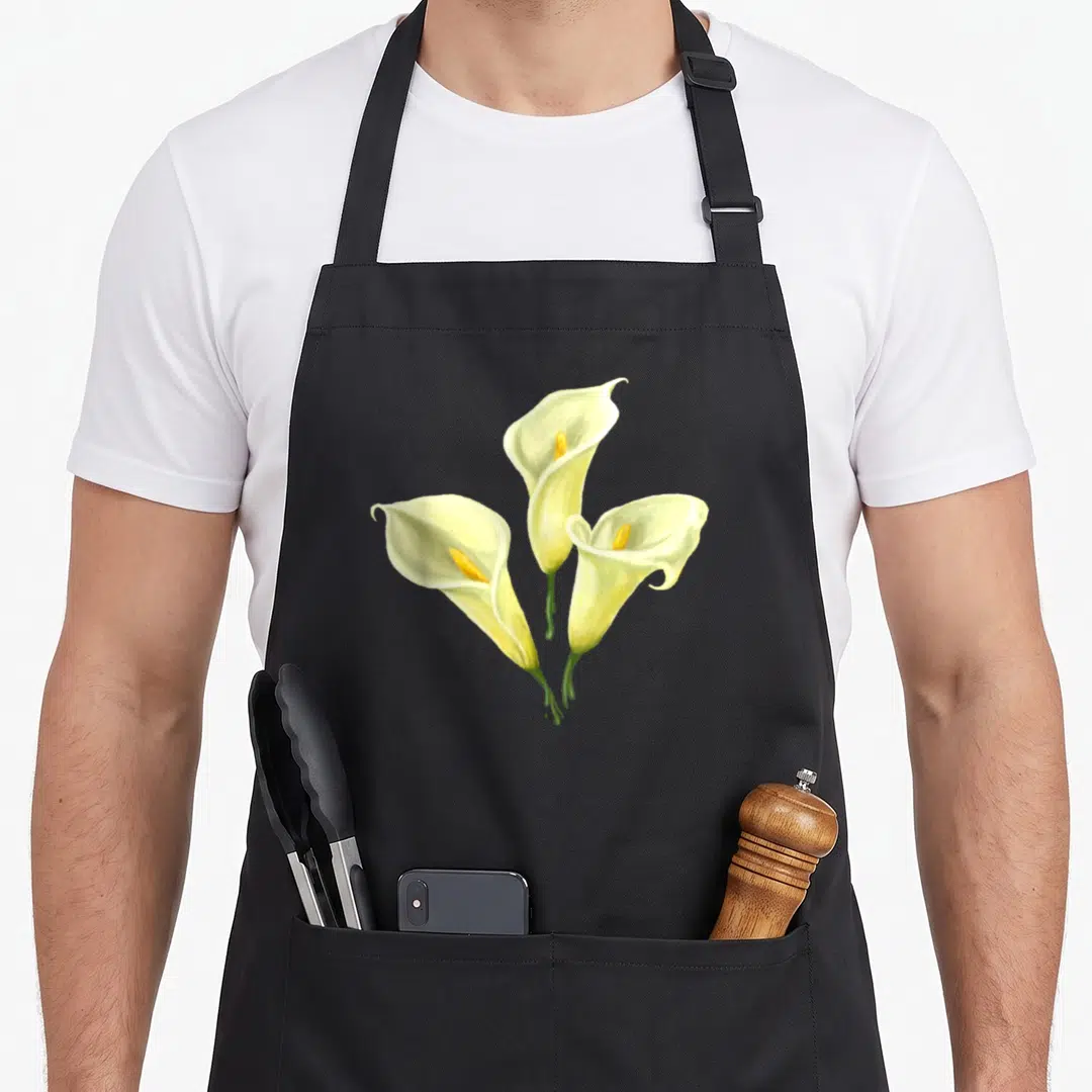 Calla white lily apron - Three realistic calla lilies in white yellow and green with stems meeting at bottom — shown on a black cotton canvas apron against a white background