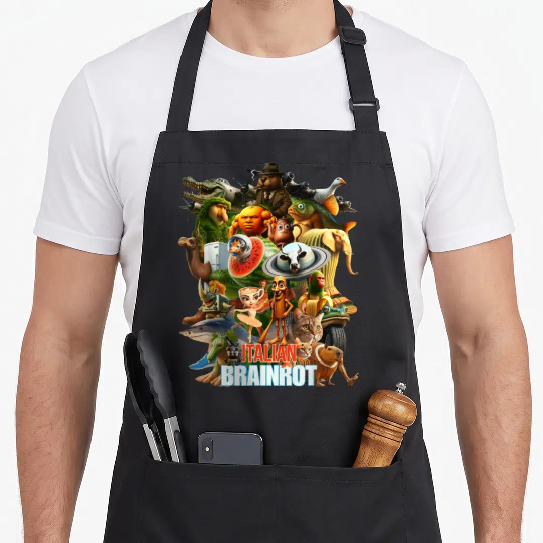 Viral italian apron - Surreal collage of animal hybrids with red and blue ITALIAN BRAINROT text — shown on a black cotton canvas apron against a white background
