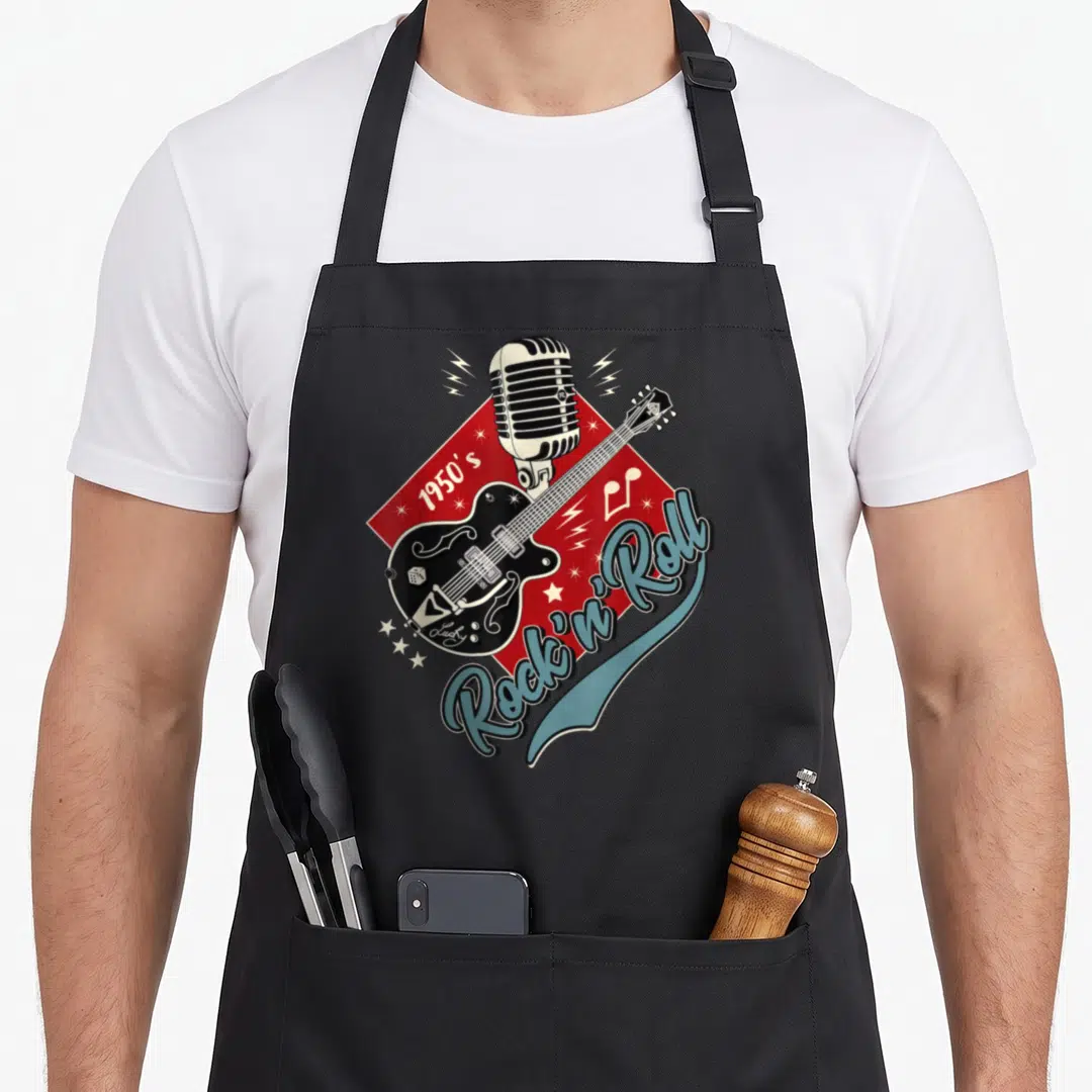 Hop rockabilly apron - Black guitar and white mic on red rhombus with 1950s Rock n Roll blue script — shown on a black cotton canvas apron against a white background