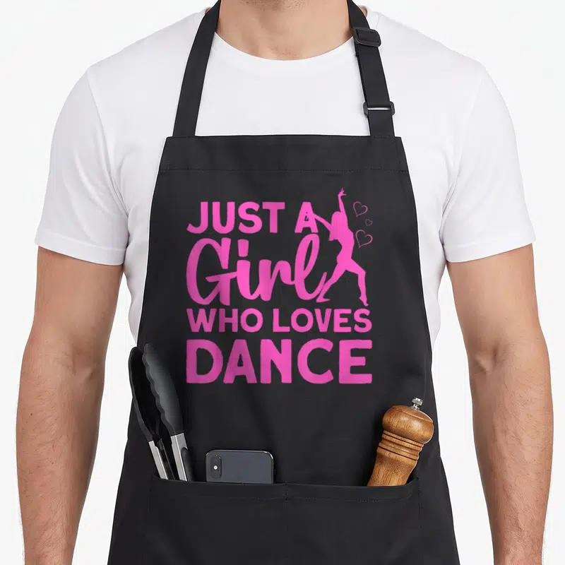 Dance hop hip apron - Pink text JUST A Girl WHO LOVES DANCE with dancer silhouette and three hearts — shown on a black cotton canvas apron against a white background