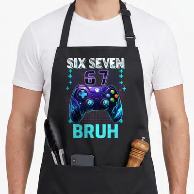 Seven bruh birthday apron - Purple game controller with SIX SEVEN 67 BRUH text and blue grid background — shown on a black cotton canvas apron against a white background