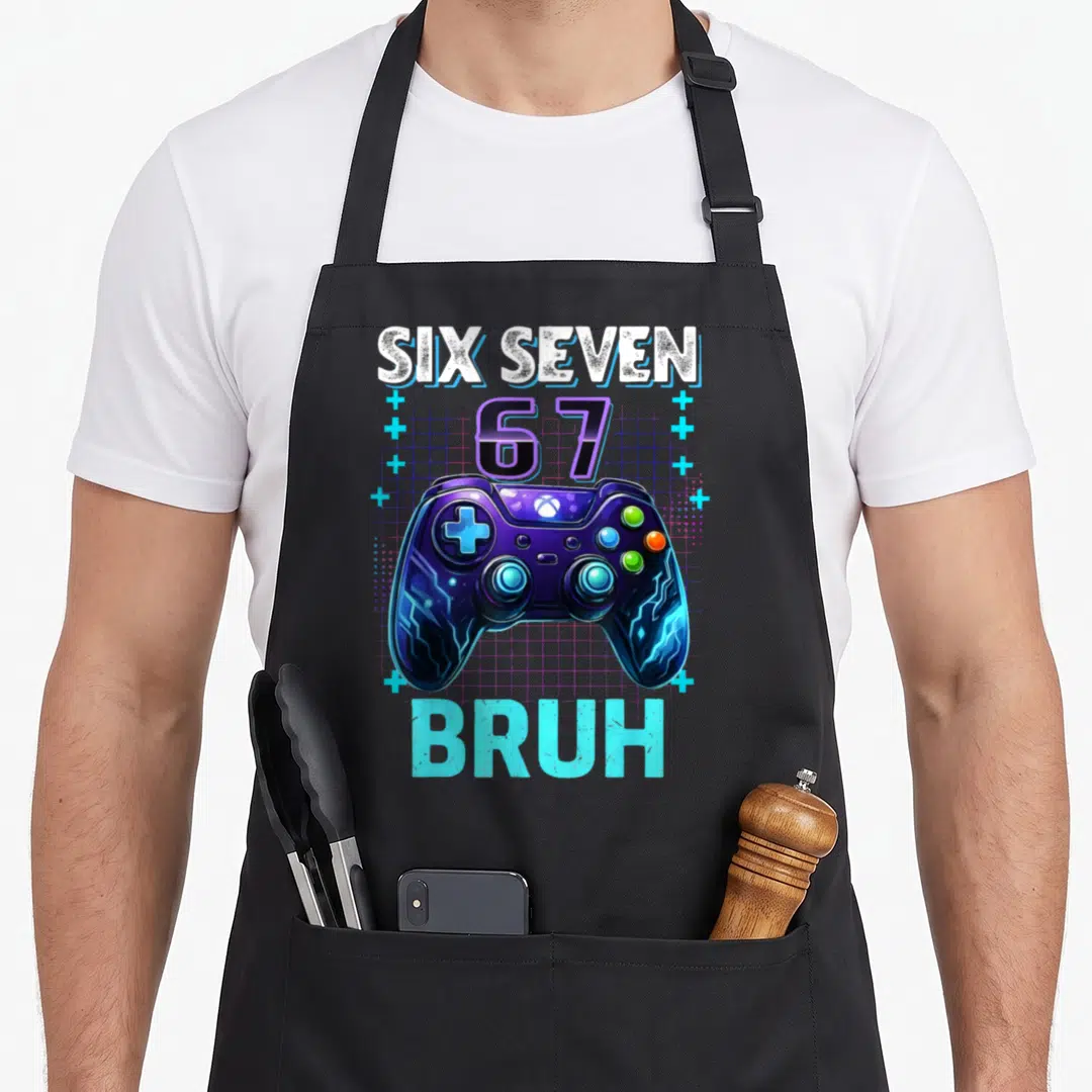 Seven bruh birthday apron - Purple game controller with SIX SEVEN 67 BRUH text and blue grid background — shown on a black cotton canvas apron against a white background