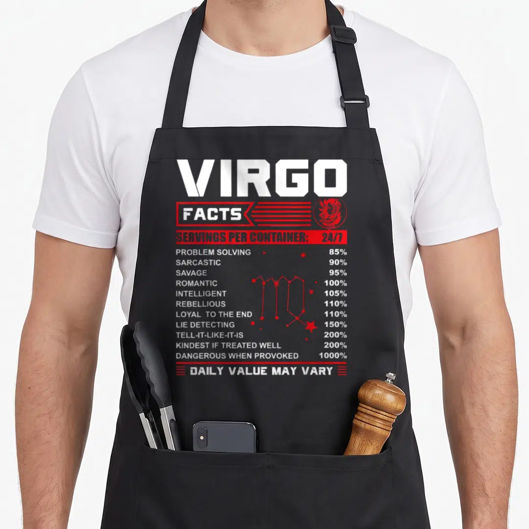 Fact birthday apron - Virgo nutrition facts label design with red constellation and trait percentages — shown on a black cotton canvas apron against a white background