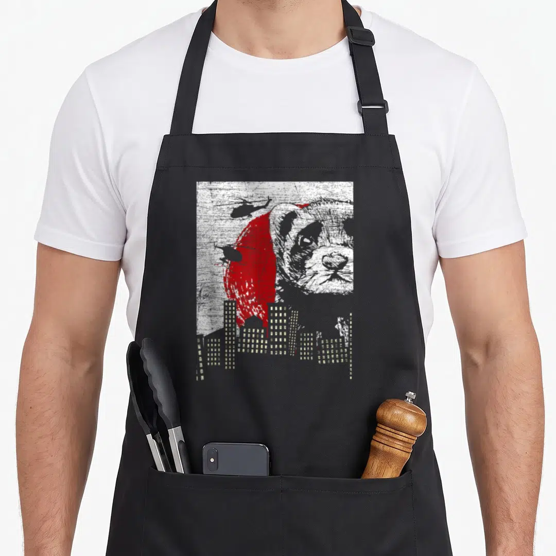 Weasel pet apron - Distressed panda head over red circle with helicopters and grey city skyline — shown on a black cotton canvas apron against a white background