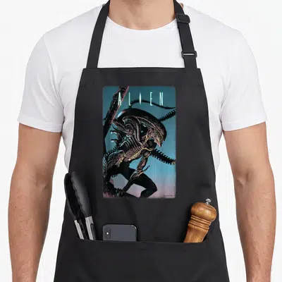Alien 20th century studios apron - Realistic Xenomorph illustration with ALIEN text in black blue purple and yellow — shown on a black cotton canvas apron against a white background