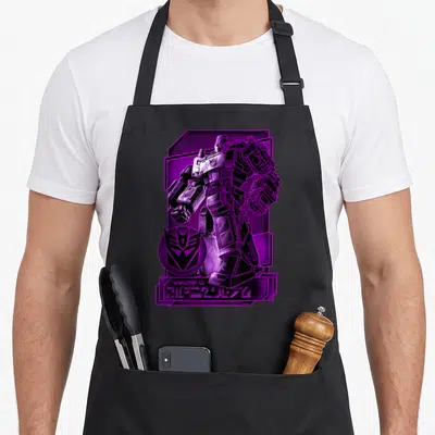 Megatron transformer apron - Standing robot in purple and black with circular logo and stylized text at bottom — shown on a black cotton canvas apron against a white background
