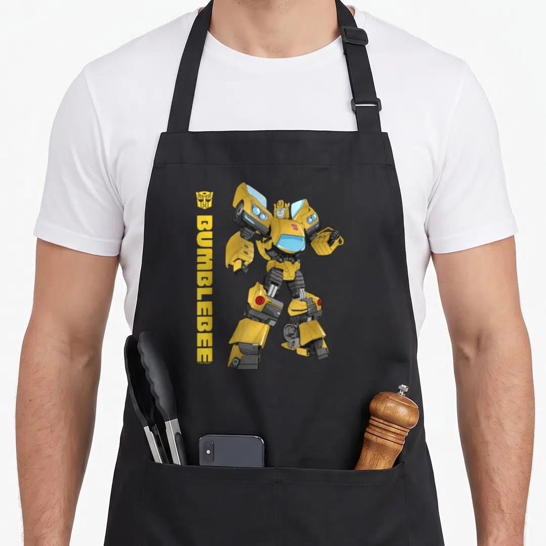 Epic bumblebee apron - Vertical BUMBLEBEE text and standing yellow robot figure in cartoon style — shown on a black cotton canvas apron against a white background