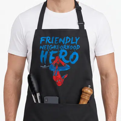 Homecoming crawler guy apron - Spider-Man hanging upside down below blue friendly neighborhood hero text — shown on a black cotton canvas apron against a white background