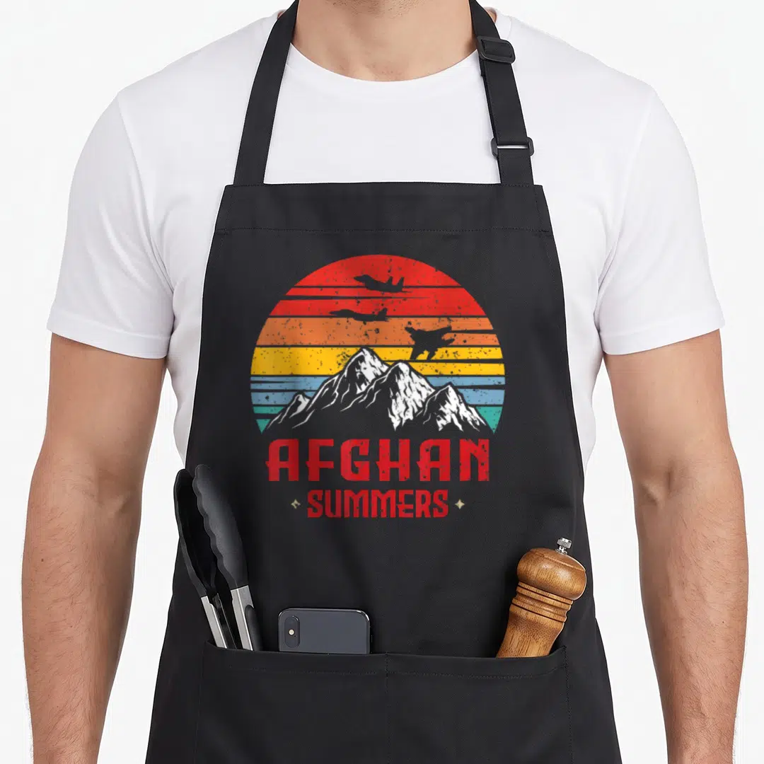 Afghan summer aprons - Retro sun stripes mountains planes AFGHAN SUMMERS text — shown on a black cotton canvas apron against a white background