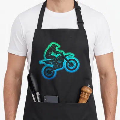 Motocross enduro bike apron - Minimalist dirt bike rider silhouette with blue green cyan gradient aura on black fabric — shown on a black cotton canvas apron against a white background