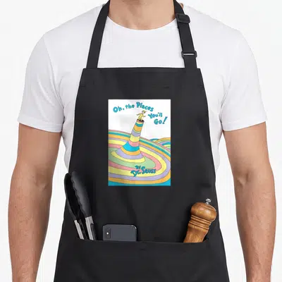 Book you youll apron - Cartoon character on striped tube with blue text Oh the Places You'll Go By Dr Seuss — shown on a black cotton canvas apron against a white background