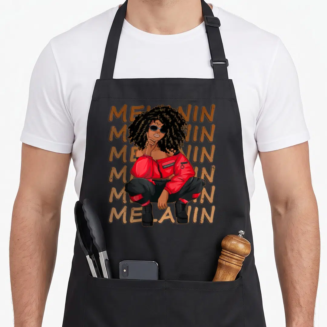 Melanin hair apron - Woman crouching in front of six stacked Melanin words in brown, red, and black — shown on a black cotton canvas apron against a white background