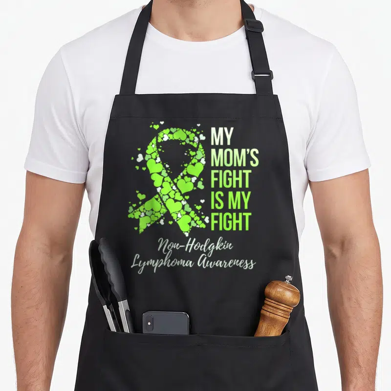Fight doctor dad apron - Lime green heart ribbon and My Mom's Fight Is My Fight text for lymphoma awareness — shown on a black cotton canvas apron against a white background