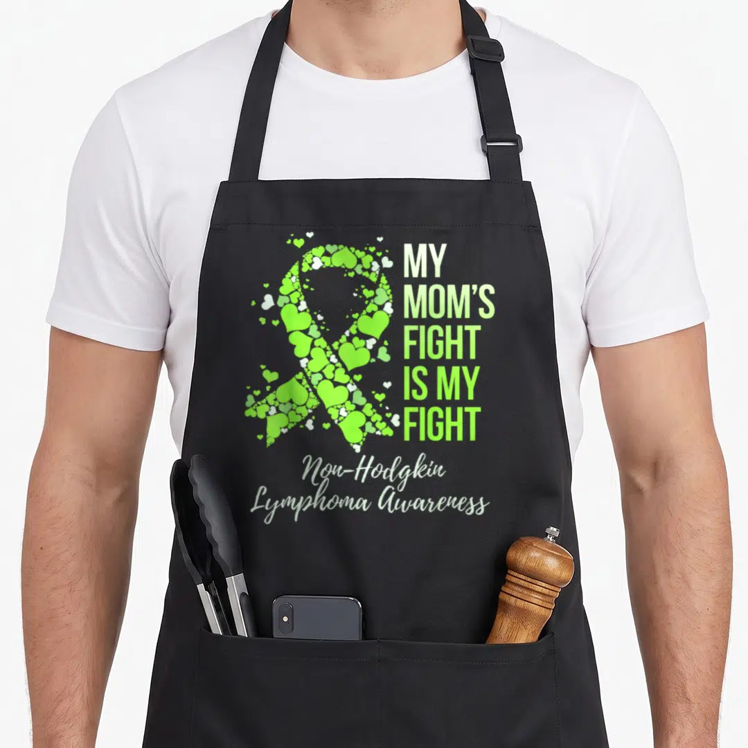 Fight doctor dad apron - Lime green heart ribbon and My Mom's Fight Is My Fight text for lymphoma awareness — shown on a black cotton canvas apron against a white background