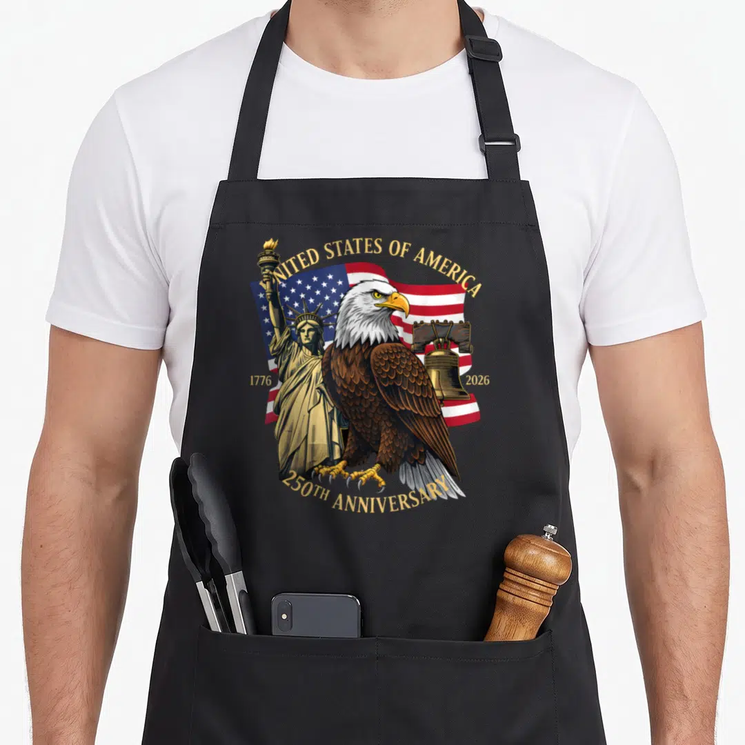250th eagles apron - Bald eagle, US flag, Statue of Liberty, Liberty Bell, gold text 250th anniversary — shown on a black cotton canvas apron against a white background