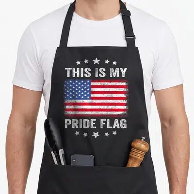 Pride flag patriotic 4th of july apron - Distressed USA flag with THIS IS MY PRIDE FLAG text and five star arches — shown on a black cotton canvas apron against a white background