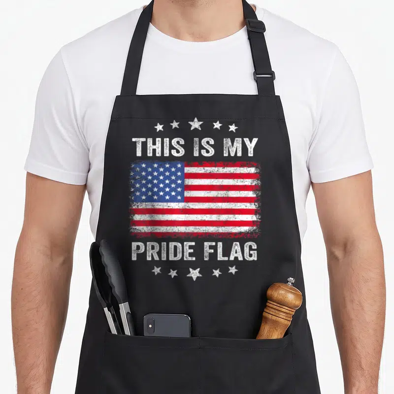 Pride flag patriotic 4th of july apron - Distressed USA flag with THIS IS MY PRIDE FLAG text and five star arches — shown on a black cotton canvas apron against a white background