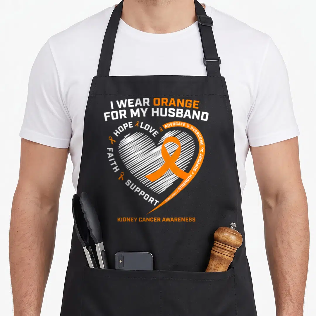 Family husband wife aprons - Orange ribbon inside white sketched heart with supportive text for kidney cancer awareness — shown on a black cotton canvas apron against a white background
