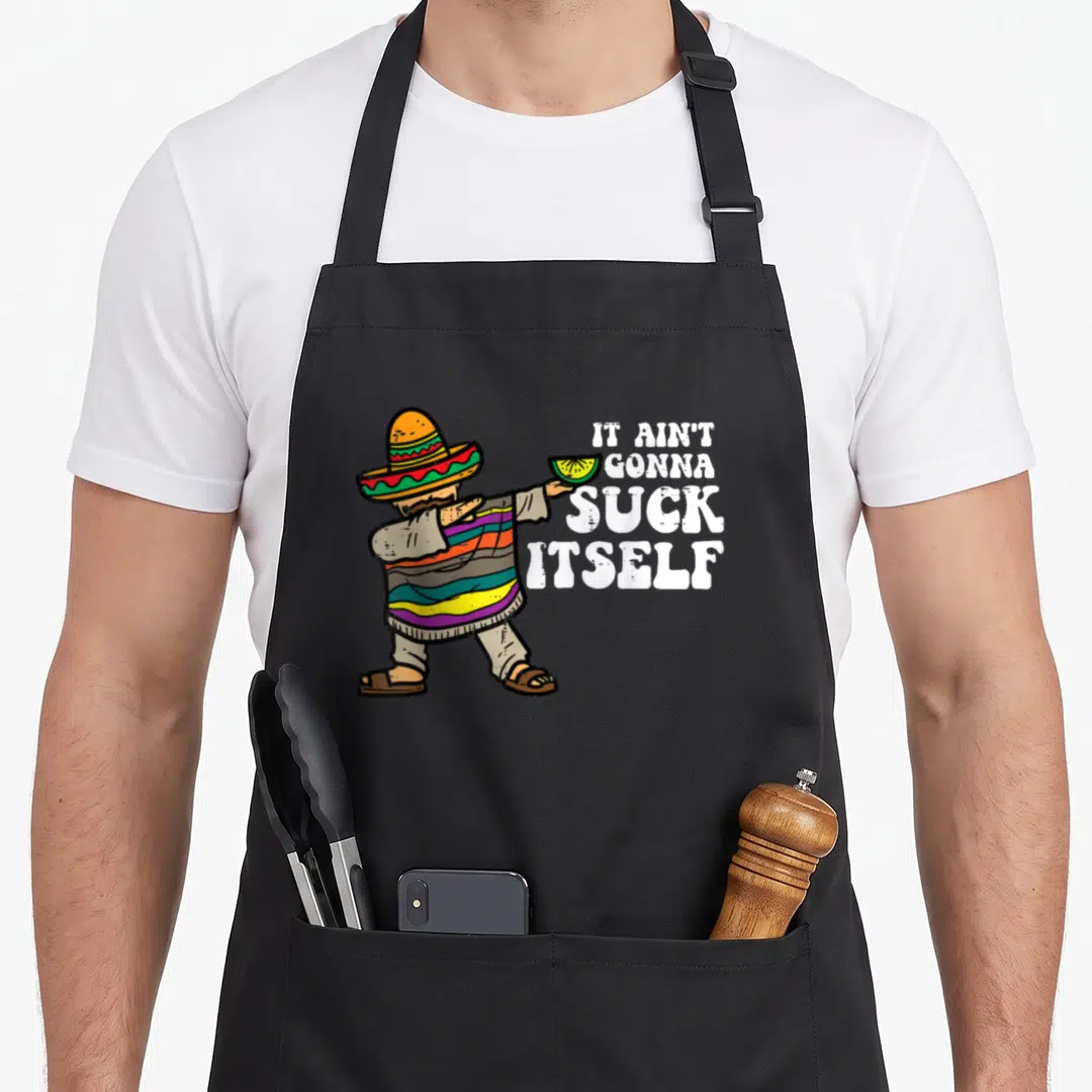 Suck mexican apron - Cartoon man in striped poncho holds lime slice next to stacked IT AIN'T GONNA SUCK ITSELF text — shown on a black cotton canvas apron against a white background
