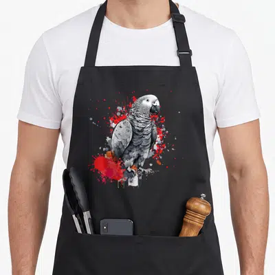 Parrot african aprons for men - Realistic grey parrot with red and white paint splatters on black apron — shown on a black cotton canvas apron against a white background