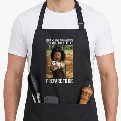 Hello princess apron - Photo of man pointing sword with Hello My Name Is Inigo Montoya You Killed My Father Prepare — shown on a black cotton canvas apron against a white background