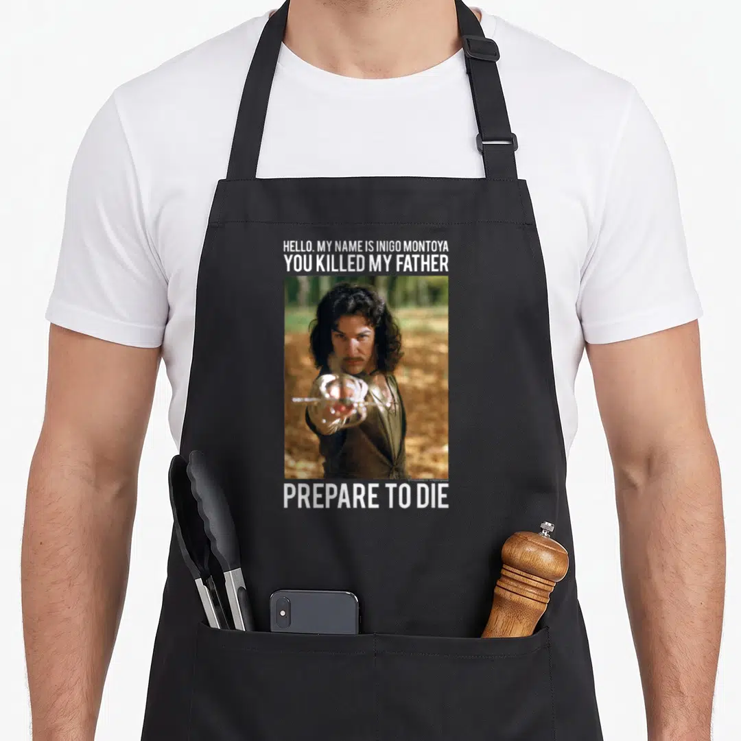Hello princess apron - Photo of man pointing sword with Hello My Name Is Inigo Montoya You Killed My Father Prepare — shown on a black cotton canvas apron against a white background