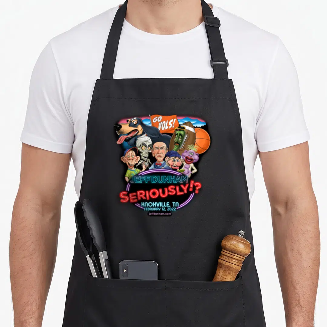 Jeff dunham knoxville apron - Caricatures and neon text reading Jeff Dunham Seriously Knoxville Feb 12 2022 — shown on a black cotton canvas apron against a white background