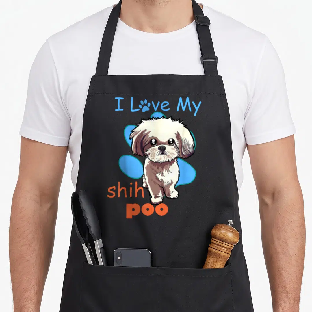 Shih paw print apron - Cartoon Shih Poo dog with I Love My shih poo text and blue blob background — shown on a black cotton canvas apron against a white background