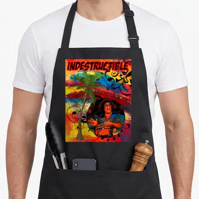 Fania congas apron - INDESTRUCTIBLE text above retro conga player in circle with palm tree and colorful abstract — shown on a black cotton canvas apron against a white background
