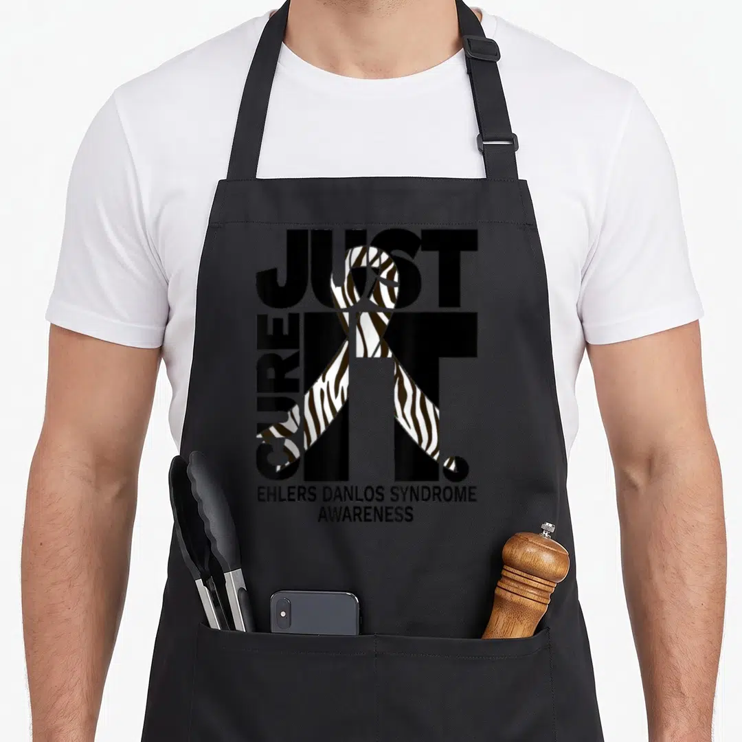 Ehler danlo eds awareness apron - Just Cure It zebra ribbon typography EHLERS DANLOS SYNDROME AWARENESS text design — shown on a black cotton canvas apron against a white background