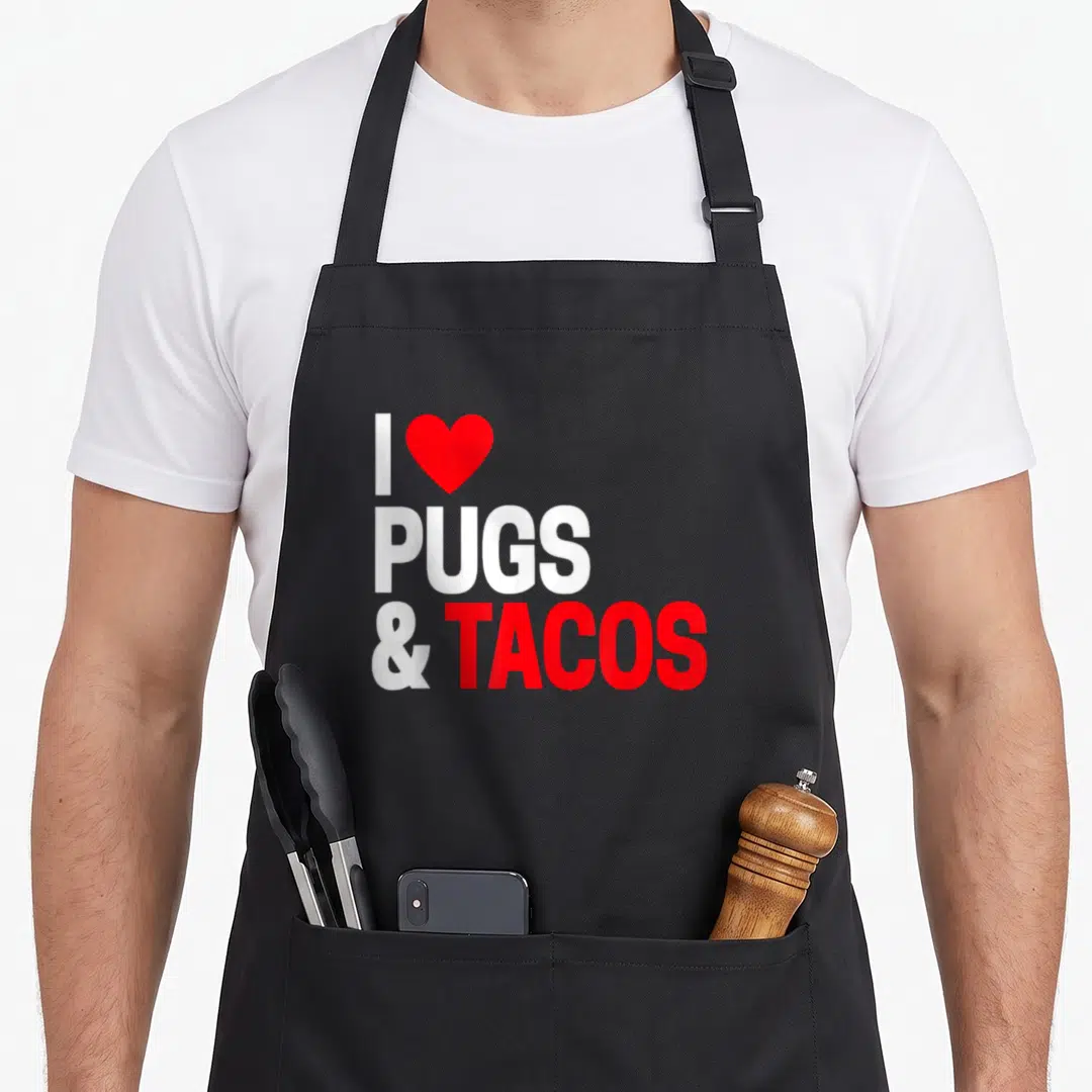 Taco custom dog apron - Red heart and text reading I Pugs & Tacos in white and red typography — shown on a black cotton canvas apron against a white background